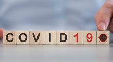 Tiles spelling out "COVID-19"